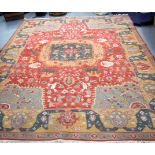 A LARGE RED GROUND EASTERN CARPET RUG, decorated with animals and foliage. 308 cm x 244 cm.