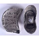 TWO CHINESE WHITE METAL INGOTS, varying form, weight 397 grams. Largest 8 cm wide.