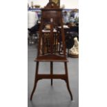 A LARGE EDWARDIAN WOODEN EASEL, decorated with satinwood foliage. 162 cm x 72 cm.