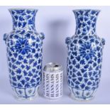 A LARGE PAIR OF 19TH CENTURY CHINESE BLUE AND WHITE VASES painted with flowers. 29.5 cm high.