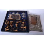 A CASED CHESS SET, together with a picture frame. Frame 27 cm x 18.5 cm.