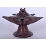 AN ISLAMIC BRONZE OIL LAMP, formed with a beast head cover. 9.5 cm x 13.25 cm.