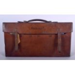 AN ANTIQUE LEATHER TRAVEL BAG, containing maps and a book. 41 cm wide.