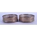 A PAIR OF ENGLISH SILVER BOTTLE COASTERS. London 1986. 12 cm diameter.