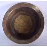 A HUGE ISLAMIC BRASS BASIN, decorated with a central mythical creature and symbols. 15 cm x 43 cm.