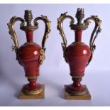 A PAIR OF 19TH CENTURY ORMOLU MOUNTED RED BLOODSTONE VASES converted to lamps. 30 cm x 14 cm.