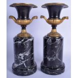 A PAIR OF GRAND TOUR STYLE TWIN HANDLED CAMPAGNA URNS After the Antique, upon marble pedestals. 30 c