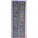 A PAIR OF EARLY 20TH CENTURY CHINESE FRAMED SILKWORK SLEEVES decorated with butterflies and foliage.