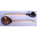 TWO MIDDLE EASTERN OTTOMAN CARVED BONE AND HORN SPOONS. 26 cm long. (2)