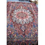 A LARGE RED GROUND PERSIAN CARPET RUG, decorated with extensive foliage. 295 cm x 214 cm.