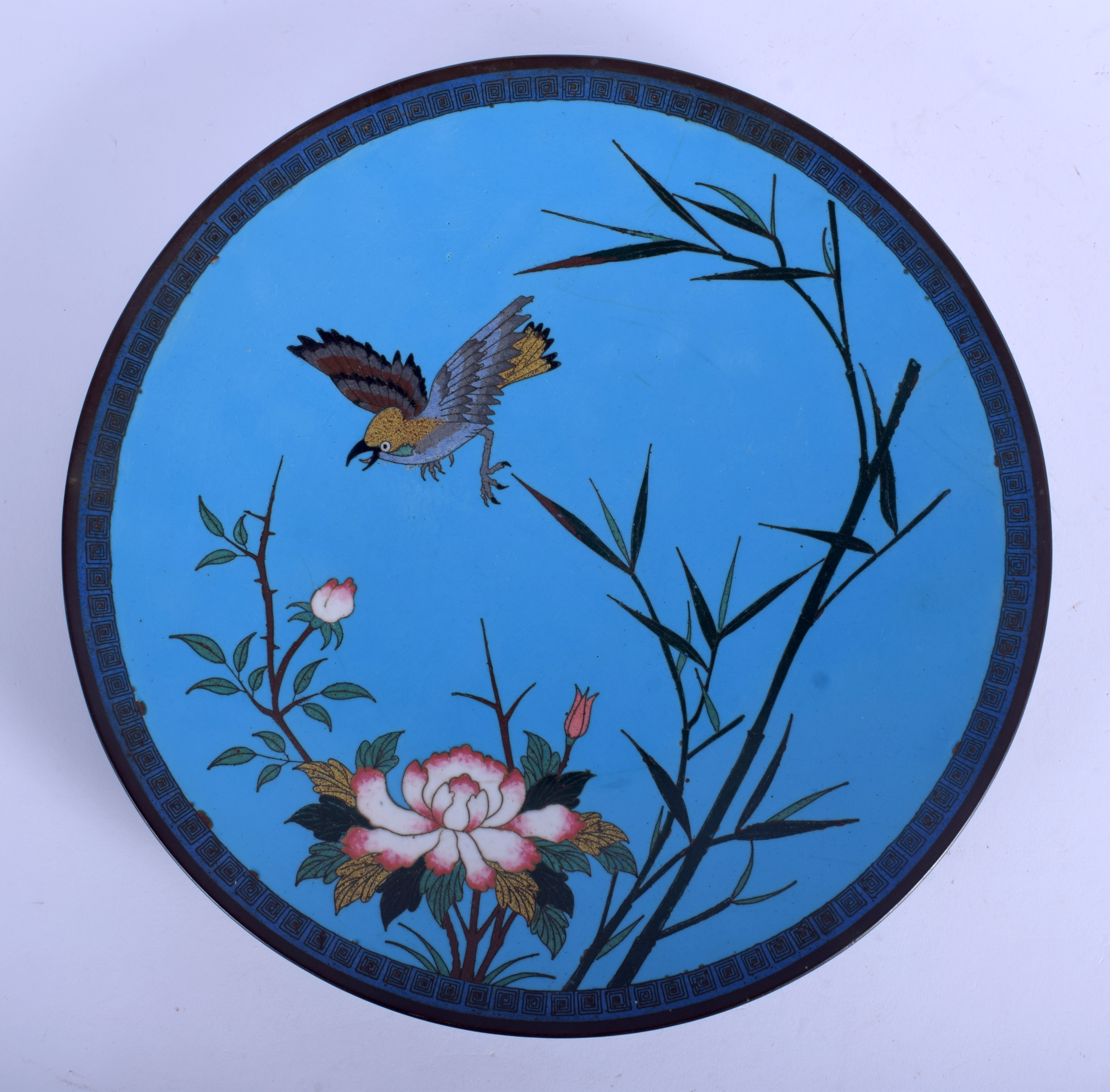 A 19TH CENTURY JAPANESE MEIJI PERIOD CLOISONNE ENAMEL DISH decorated with a bird in flight. 30 cm di