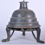 AN ISLAMIC BRONZE OIL LAMP, engraved with symbols and calligraphy. 52 cm high.