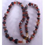 AN ISLAMIC AGATE NECKLACE, formed with varied spherical beads. 44 cm long.