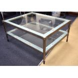 A LARGE 1950'S COFFEE TABLE, two tier with reeded legs and painted with sprays of foliage. 47 cm x 1