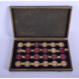 A SET OF 19TH CENTURY CARVED AND STAINED IVORY DRAUGHTS SET. Each 3 cm diameter.