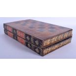 A VINTAGE LEATHER FAUX BOOK FOLDING CHESS GAMING BORD. 42 cm x 37 cm open.