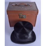 AN ANTIQUE CASED TOP HAT within a leather box, Walter Barard & Son London. Internal measurement 16 c