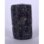 AN UNUSUAL EASTERN HARDSTONE BEAD, carved with figures and symbols. 3.75 cm long.