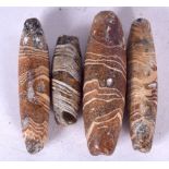 FOUR ROMAN GLASS BEADS, varying size. Largest 5 cm long. (4)