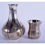 AN ANTIQUE MIDDLE EASTER PERSIAN SILVER BOTTLE with matching beaker. 19 cm & 9 cm high. 21 oz. (2)