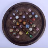 VICTORIAN SOLITAIRE MARBLES upon a stand. Largest 2.5 cm wide. (33)