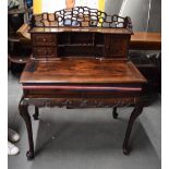 AN EARLY 20TH CENTURY CHINESE CARVED HARDWOOD DESK formed with two short drawers. 121 cm x 91 cm.