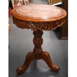 A CHINESE MARBLE INSET HARDWOOD TRIPOD TABLE STAND, formed with a carved foliate frieze. 75 cm x 53.