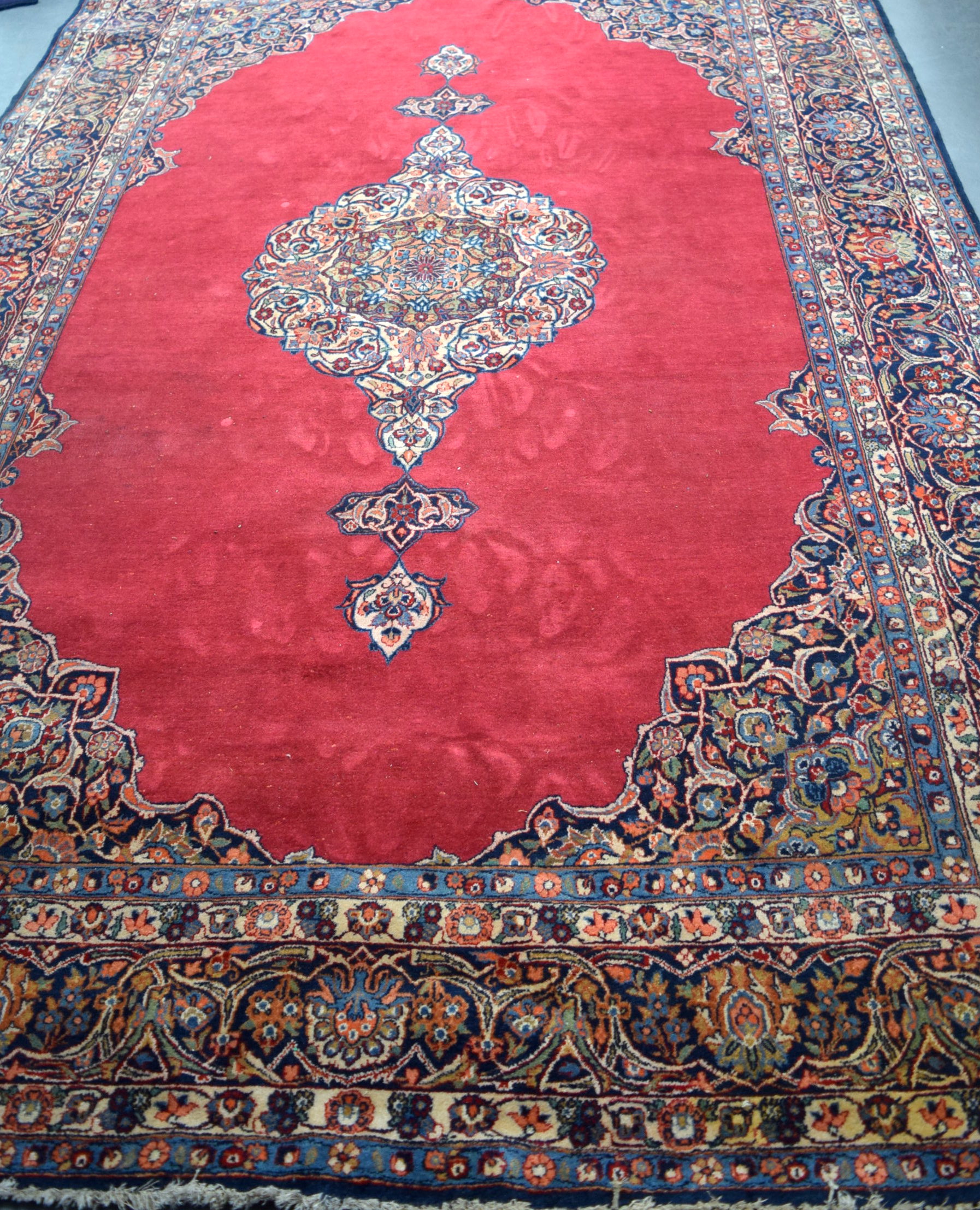 A LARGE RED GROUND PERSIAN RUG CARPET, decorated with extensive foliage. 328 cm x 218 cm.