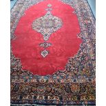 A LARGE RED GROUND PERSIAN RUG CARPET, decorated with extensive foliage. 328 cm x 218 cm.