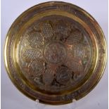 AN EARLY 20TH CENTURY ISLAMIC SILVER INLAID BRASS DISH, decorated with panels of script. 28 cm wide.