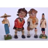 A PAIR OF VINTAGE CLOCKWORK SCOTSMAN, together with two wooden figures. Largest 23 cm. (4)