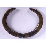 A RARE LATE BRONZE AGE PENDANT, in the form of opposing boar tusks. 12.5 cm wide.