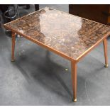 A STYLISH 1950'S ABSTRACT COFFEE TABLE, formed upon splayed copper legs. 44 cm x 84.5 cm.