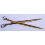 A PAIR OF TURKISH MIDDLE EASTERN ENGRAVED BRASS CALLIGRAPHY SCISSORS. 25 cm long.