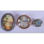 THREE ANTIQUE PAINTED SILVER LANDSCAPE BROOCHES. Largest 4 cm x 5 cm. (3)