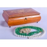 A JEWELLERY BOX with necklaces. (4)