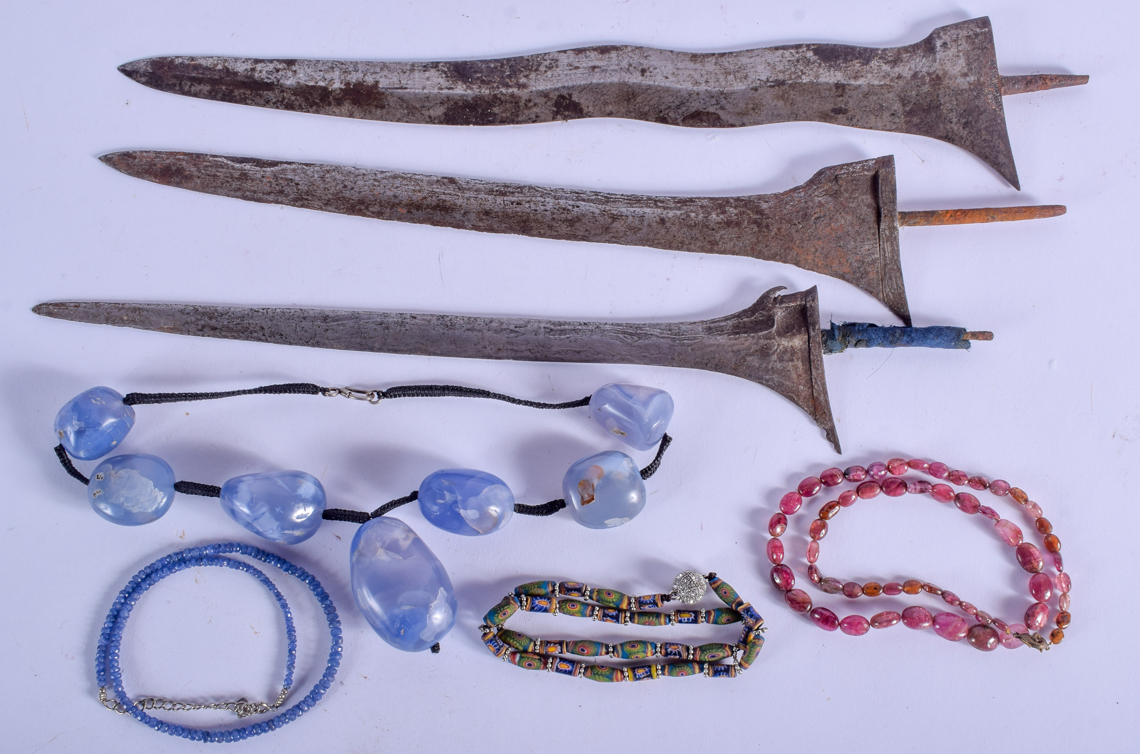 FOUR CENTRAL ASIAN NECKLACES together with three dagger blades. (7)