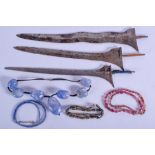 FOUR CENTRAL ASIAN NECKLACES together with three dagger blades. (7)