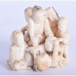 A 19TH CENTURY JAPANESE MEIJI PERIOD CARVED IVORY OKIMONO depicting figures on a hobby horse. 5.5 c