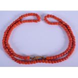 AN 18CT GOLD AND CORAL NECKLACE. 78 cm long, largest bead 0.5 cm x 0.5 cm. 67 grams.