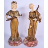 A LARGE PAIR OF ART NOUVEAU BRONZE AND IVORY FIGURES depicting musicians, upon marble bases. 30 cm