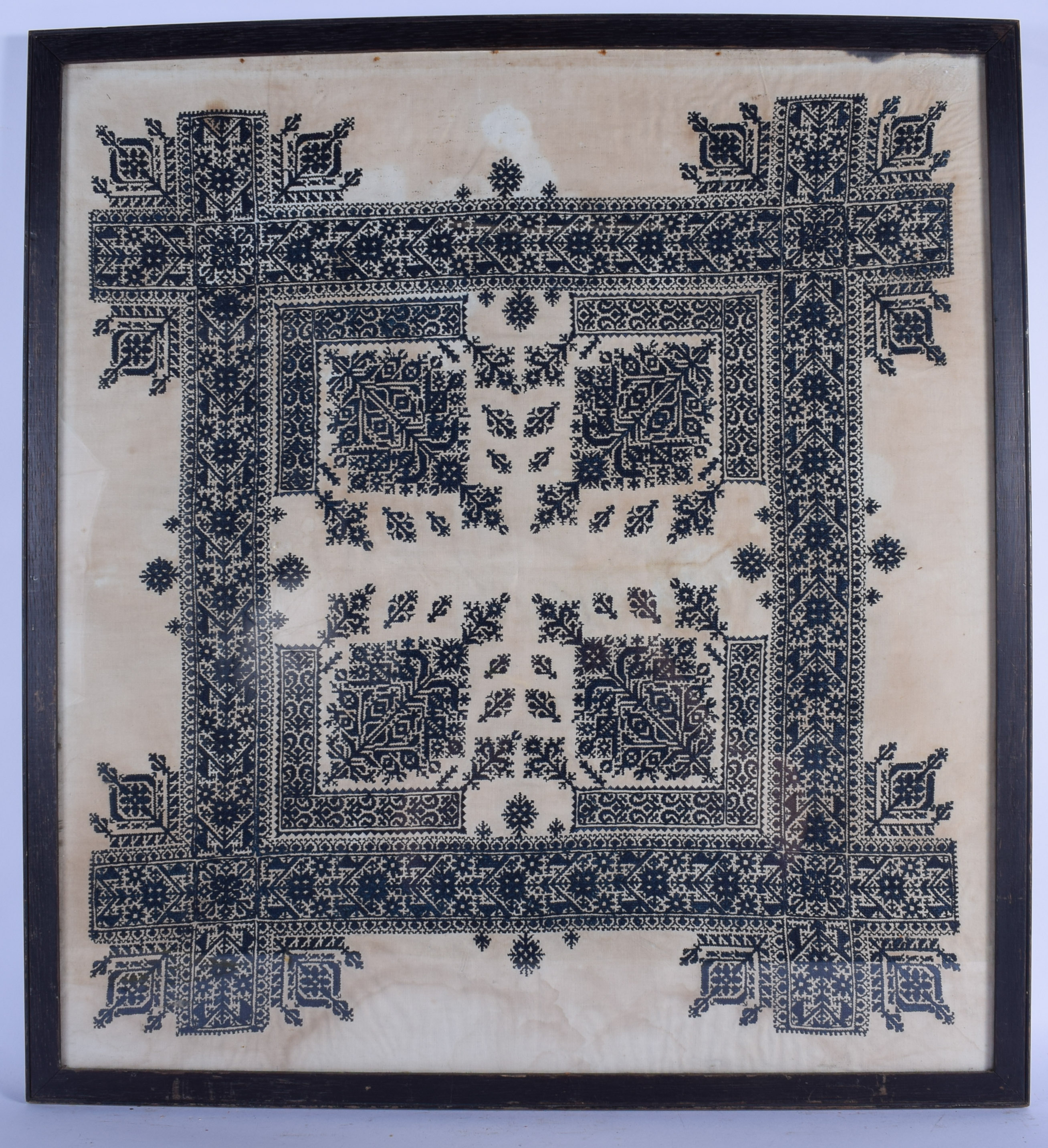 A FRAMED BURMESE EMBROIDERY, depicting a geometric pattern. 66 cm x 61 cm.
