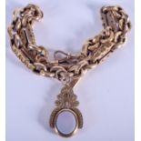 AN ANTIQUE 9CT GOLD CHAIN with attached 15ct gold mounted swivel fob. 55 grams. 37 cm long.