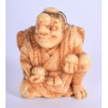 A 19TH CENTURY CARVED IVORY NETSUKE in the form of a seated buddhistic male. 3.75 cm x 2.75 cm.