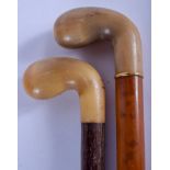 TWO 19TH CENTURY CARVED HORN HANDLED WALKING CANES. 86 cm long. (2)