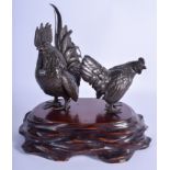 A GOOD 19TH CENTURY JAPANESE MEIJI PERIOD BRONZE OKIMONO modelled as two fowl upon a wooden base. B