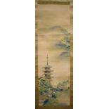 A JAPANESE WATERCOLOUR SCROLL PAINTING, depicting a pagoda in a landscape. 114 cm x 36 cm.