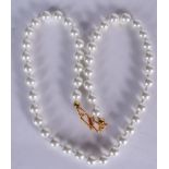 A VINTAGE PEARL NECKLACE, formed with a yellow metal clasp. 42 cm long.