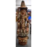 A LARGE NIGERIAN YORUBA POLYCHROMED WOODEN STATUE, formed as a standing figure with attendants in v