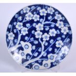 AN EARLY 20TH CENTURY JAPANESE BLUE ND WHITE PORCELAIN DISH, decorated with prunus in the Chinese t